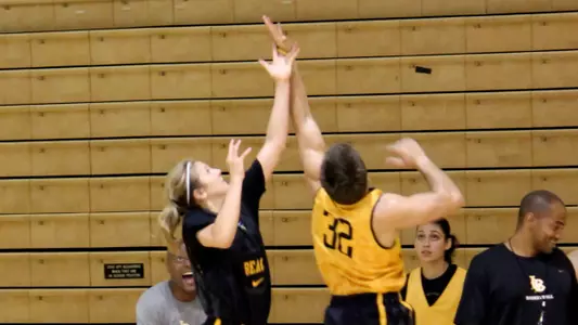 Lauren Spargo goes up for a rebound against one of the 49er practice players.
