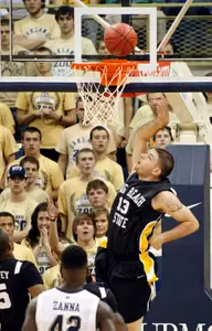 Long Beach State's Edis Dervisevic drops in a layup after getting past Pittsburgh's Talib Zanna. (AP Photo/Keith Srakocic)