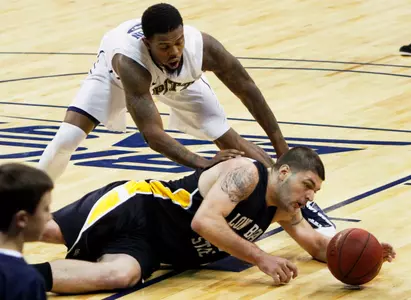 Long Beach State's Edis Dervisevic, bottom, tries to control the ball from the floor as Pittsburgh's Nasir Robinson defends in the first half. (AP Photo/Keith Srakocic)