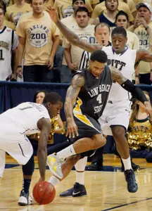 Pittsburgh's Tray Woodall  gets the ball as Long Beach State's Eugene Phelps  loses it as he is fouled by Pittsburgh's Dante Taylor in the first half. (AP Photo/Keith Srakocic)