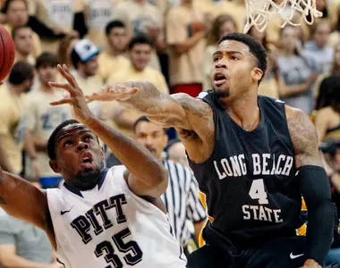 Pittsburgh's Nasir Robinson is fouled by Long Beach State's Eugene Phelps while shooting in the first half. (AP Photo/Keith Srakocic)