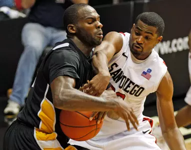 San Diego St. Chase Tapley battles Long Beach St.'s Larry Anderson for the ball during the second half of a NCAA college basketball game  Saturday, Nov. 19, 2011 in San Diego. (AP Photo/Lenny Ignelzi)
