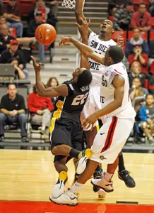 Long Beach State guard Casper Ware (22) is blocked by San Diego State's Xavier Thames, right, in the second half of an NCAA college basketball game on Saturday, Nov. 19, 2011, in San Diego. San Diego State won 77-73 in overtime. (AP Photo/Lenny Ignelzi)