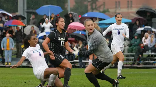 Freshman Ashley Roese chips the ball past San Diego's goalkeeper for her first career goal. <i>(Photo by Jeff Sipsey)</i>