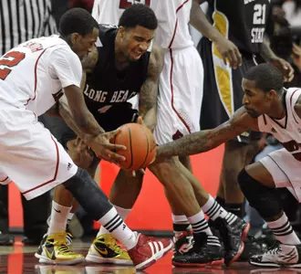 Long Beach State's Eugene Phelps, center, battles Louisville's Russ Smith, left, and Chris Smith during the second half of their NCAA college basketball game, Monday, Nov. 28, 2011, in Louisville, Ky. Louisville defeated Long Beach State 79-66. (AP Photo/Timothy D. Easley)