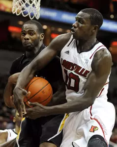 Louisville's Gorgui Dieng, right, battles Long Beach State's Larry Anderson for a rebound during the second half of their NCAA college basketball game, Monday, Nov. 28, 2011, in Louisville, Ky. Louisville defeated Long Beach State 79-66. (AP Photo/Timothy D. Easley)