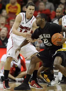 Long Beach State's Larry Anderson, right, tries to get around the defense of Louisville's Kyle Kuric during the first half of their NCAA college basketball game, Monday, Nov. 28, 2011, in Louisville, Ky. (AP Photo/Timothy D. Easley)