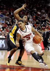 Louisville's Peyton Siva, right, drives around the defense of Long Beach State's Casper Ware during the first half of their NCAA college basketball game, Monday, Nov. 28, 2011, in Louisville, Ky. (AP Photo/Timothy D. Easley)