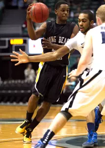 Long Beach State guard Casper Ware works the ball against Xavier during the first half.  (AP Photo/Marco Garcia)