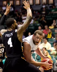 Xavier center Kenny Frease tries to get around Long Beach State forward Eugene Phelps during the second half.  (AP Photo/Marco Garcia)