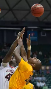 Auburn forward Adrian Forbes (45) fouls Long Beach State guard Larry Anderson (21) in the second half of an NCAA college basketball game Friday, Dec. 23, 2011, in Honolulu. Long Beach State defeated Auburn 64-43. (AP Photo/Eugene Tanner)