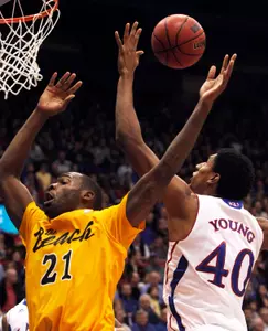 Kansas forward Kevin Young and Long Beach State guard Larry Anderson battle for a rebound. (AP Photo/Orlin Wagner)
