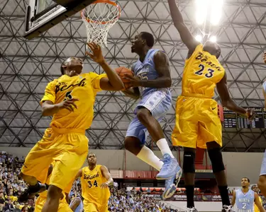North Carolina's Reggie Bullock, middle, drives to the basket between Long Beach State's Mike Caffey, left, and Deng Deng during the first half of an NCAA college basketball game in Long Beach, Calif. Friday, Nov. 16, 2012. (AP Photo/Chris Carlson)