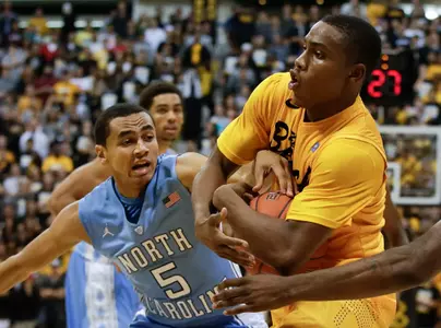Long Beach State's Mike Caffey, right, pulls a rebound away from North Carolina's Marcus Paige during the second half of an NCAA basketball game in Long Beach, Calif. Friday, Nov. 16, 2012. (AP Photo/Chris Carlson)