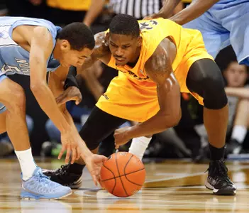 North Carolina's Marcus Paige, left, battles Long Beach State's Dan Jennings for a loose ball during the first half of an NCAA basketball  game in Long Beach, Calif. Friday, Nov. 16, 2012. (AP Photo/Chris Carlson)