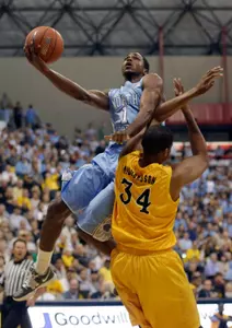 North Carolina's Dexter Strickland, top, drives to the basket past Long Beach State's Kyle Richardson during the first half of an NCAA college basketball game in Long Beach, Calif., Friday, Nov. 16, 2012. (AP Photo/Chris Carlson)