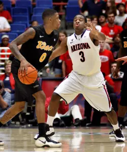 Long Beach State's Kris Gulley (0) looks to pass the ball against Arizona's Kevin Parrom (3) during the second half of an NCAA college basketball game in Tucson, Ariz., Monday, Nov. 19, 2012. Arizona won 94-72. (AP Photo/Wily Low)
