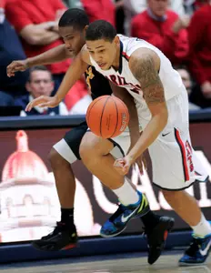 Arizona's Brandon Ashley, right, struggles with Long Beach State's Mike Caffey for a loose ball during the first half of an NCAA college basketball game in Tucson, Ariz., Monday, Nov. 19, 2012. (AP Photo/John Miller)