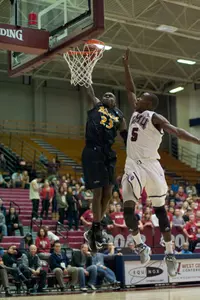 Deng Deng scores a breakaway dunk, part of a career-high 14 points for the freshman.