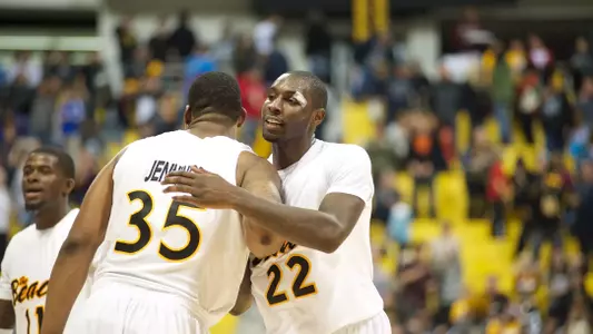 Tony Freeland and Dan Jennings celebrate after the 67-63 win against Pacific Saturday afternoon at the Water Pyramid.