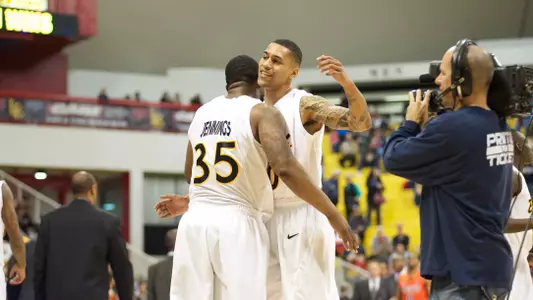 Keala King and Dan Jennings celebrate after defeating Pacific 67-63 Saturday afternoon at the Walter Pyramid.