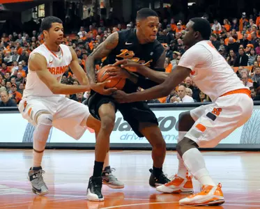 Syracuse's Michael Carter-Williams, left, and Jerami Grant, right, pressure Long Beach State's Kris Gulley. (AP Photo/Kevin Rivoli)