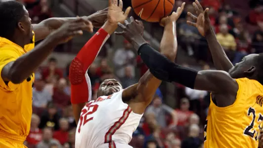 Ohio State's Lenzelle Smith Jr., center, goes up for a shot between Long Beach State's James Ennis, left, and Deng Deng during the first half of an NCAA college basketball game in Columbus, Ohio, Saturday, Dec. 8, 2012. (AP Photo/Paul Vernon)