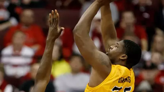 Long Beach State's Dan Jennings (35) goes up for a shot over Ohio State's Evan Ravenel (30) and Deshaun Thomas (1) during the first half of an NCAA college basketball game in Columbus, Ohio, Saturday, Dec. 8, 2012. (AP Photo/Paul Vernon)