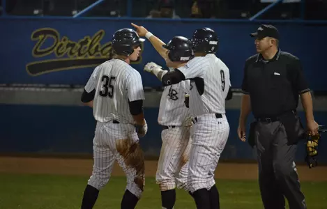 2/17/12 - Robert Vickers (35), Ino Patron (4) and Juan Avila (9) at home plate after Royce Murai (50) hit a 2-run single in the 7th inning of the Long Beach State Dirtbags.
Photo by Steven Georges/LBSU