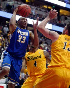 UC Santa Barbara guard Orlando Johnson (33) goes up for a shot against Long Beach State forwards Eugene Phelps (4) and Edis Dervisevic, right, during the first half of an NCAA college basketball game in the championship of their Big West Conference tournament, Saturday, March 10, 2012, in Anaheim, Calif.  (AP Photo/Alex Gallardo)