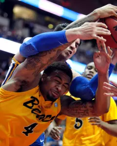 Long Beach State forward Eugene Phelps (4) battles for a loose ball against UC Santa Barbara forward Jaime Serna (0) during the first half of an NCAA college basketball game in the championship of their Big West Conference tournament, Saturday, March 10, 2012, in Anaheim, Calif. (AP Photo/Alex Gallardo)