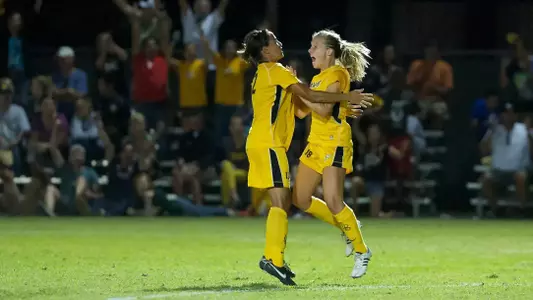 Seniors Nadia Link and Kelsey Wilson celebrate after Wilson scored the game-winning goal against Michigan. (Photos by John Fajardo/LBSU)