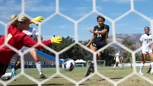 Jessika Oseguera knocks a shot past Santa Barbara Goalkeeper Beth Ritter in the Big West Conference match at Harder Stadium, Sun., Oct. 6, 2013.
