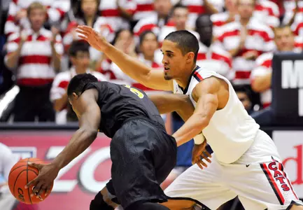Nov 11, 2013; Tucson, AZ, USA; Arizona Wildcats guard Nick Johnson (13) defends Long Beach State 49ers guard Mike Caffey (5) during the second half at McKale Center. Arizona beat Long Beach State 91-57. Mandatory Credit: Casey Sapio-USA TODAY Sports