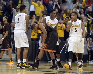 Dec 19, 2013; Long Beach, CA, USA; Long Beach State players Tyler Lamb (1), Daniel Samuels (center) and Mike Caffey (5) celebrate at the end of the game. Kirby Lee-USA TODAY Sports