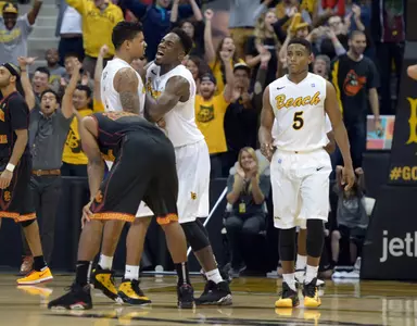 Dec 19, 2013; Long Beach, CA, USA; Long Beach State players Tyler Lamb (1), Daniel Samuels (center) and Mike Caffey (5) celebrate at the end of the game. Kirby Lee-USA TODAY Sports