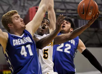 Dec 3, 2013; Long Beach, CA, USA; Long Beach State 49ers guard Mike Caffey (5) goes up for a shot defended by Creighton Bluejays center Geoffrey Groselle (41) and guard Avery Dingman (22) during the second half at Walter Pyramid. The Creighton Blue Jays defeated the Long Beach State 49ers 78-61. Mandatory Credit: Kelvin Kuo-USA TODAY Sports