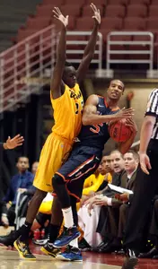 Long Beach State's Deng Deng (23) defends as Cal State Fullerton guard Kwame Vaughn (5) signals for timeout before falling out of bounds in the first half of an NCAA college basketball game in the Big West Conference men's tournament Thursday, March 14, 2013, in Anaheim, Calif. Long Beach State won 75-66. (AP Photo/Reed Saxon)