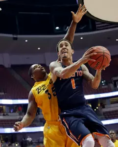 Cal State Fullerton guard Jared Brandon (1) shoots as Long Beach State forward Dan Jennings (35) defends during the second half of an NCAA college basketball game in the Big West Conference men's tournament Thursday, March 14, 2013, in Anaheim, Calif. Long Beach State won 75-66. (AP Photo/Reed Saxon)