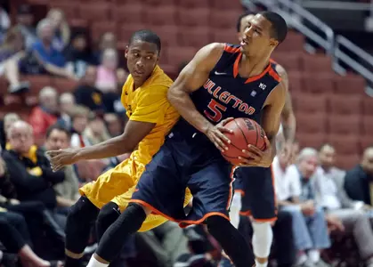Long Beach State guard Mike Caffey, left, defends Cal State Fullerton guard Kwame Vaughn at midcourt in the first half of an NCAA college basketball game in the Big West Conference men's tournament Thursday, March 14, 2013, in Anaheim, Calif. (AP Photo/Reed Saxon)