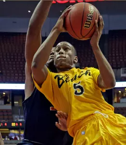 Long Beach State guard Mike Caffey (5) shoots past Cal State Fullerton forward Deuce Johnson during the first half of an NCAA college basketball game in the Big West Conference men's tournament Thursday, March 14, 2013, in Anaheim, Calif. (AP Photo/Reed Saxon)