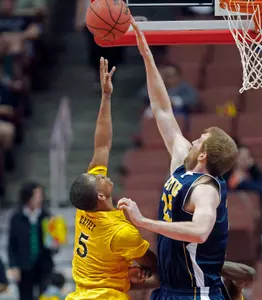 Long Beach State guard Mike Caffey (5) has his shot stopped by UC Irvine center John Ryan (25). (AP Photo/Reed Saxon)