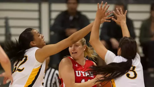 Devin Hudson and Alex Sanchez tighten up the defense in the first round of the WNIT game against Utah Wednesday night at the Walter Pyramid in Long Beach, Calif.