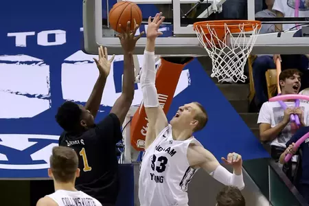 Nov 14, 2014; Provo, UT, USA; Brigham Young Cougars forward Nate Austin (33) goes to block a shot from Long Beach State 49ers forward David Samuels (11) during the second half at Marriott Center. Brigham Young Cougars won the game 95-90. Mandatory Credit: Chris Nicoll-USA TODAY Sports