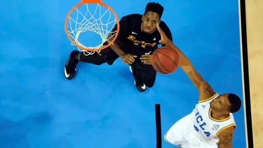 Nov 23, 2014; Los Angeles, CA, USA; UCLA Bruins guard Norman Powell (4) and Long Beach State 49ers forward David Samuels (11) reach for the ball during the first half at Pauley Pavilion. Mandatory Credit: Richard Mackson-USA TODAY Sports