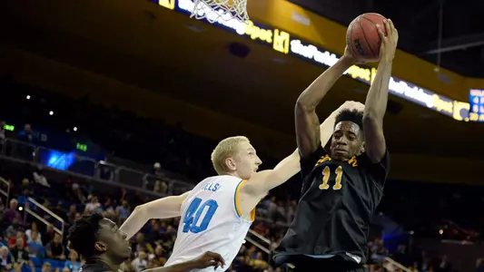 Nov 23, 2014; Los Angeles, CA, USA; Long Beach State 49ers forward David Samuels (11) pulls down a rebound against UCLA Bruins center Thomas Welsh (40) during the second half at Pauley Pavilion. Mandatory Credit: Richard Mackson-USA TODAY Sports