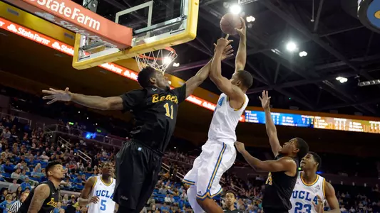 Nov 23, 2014; Los Angeles, CA, USA; UCLA Bruins guard Norman Powell (4) dunks over Long Beach State 49ers forward David Samuels (11) during the second half at Pauley Pavilion. Mandatory Credit: Richard Mackson-USA TODAY Sports