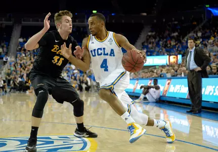 Nov 23, 2014; Los Angeles, CA, USA; UCLA Bruins guard Norman Powell (4) drives against Long Beach State 49ers forward Jack Williams (35) during the second half at Pauley Pavilion. Mandatory Credit: Richard Mackson-USA TODAY Sports