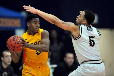 Long Beach State 49ers guard Mike Caffey (5) controls the ball against the defense of Western Michigan Broncos guard David Brown (5) during the first half at Titan Gym. Mandatory Credit: Gary A. Vasquez-USA TODAY Sports