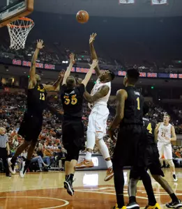 Dec 20, 2014; Austin, TX, USA; Texas Longhorns center Cameron Ridley (55) shoots against Long Beach State 49ers forwards Eric McKnight (12) and Jack Williams (35) during the first half at the Frank Erwin Special Events Center. Mandatory Credit: Brendan Maloney-USA TODAY Sports